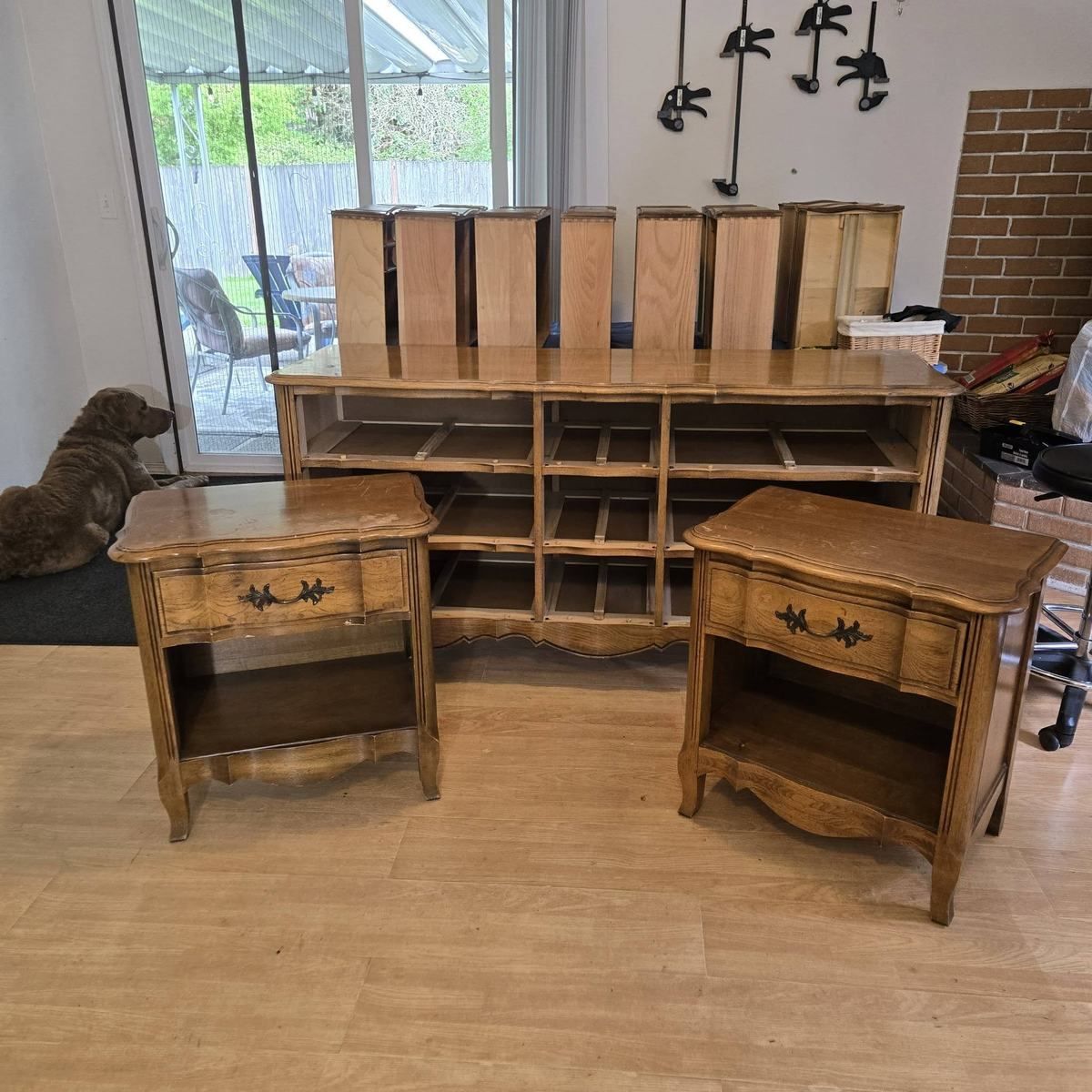 Bedroom furniture set before restoration with dated honey wood finish and pieces prepared for studio work