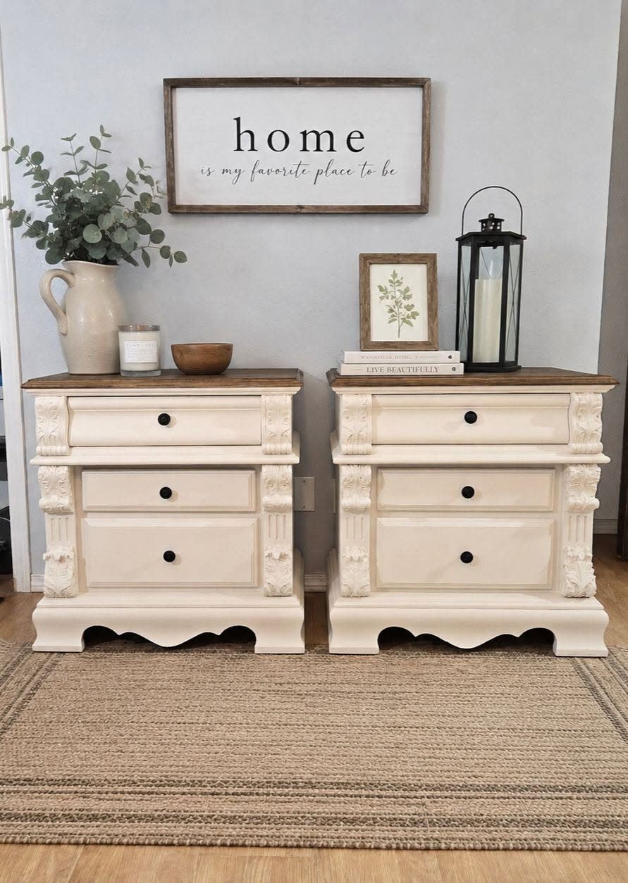 Carved nightstand pair after two-tone cream and walnut restoration — cream painted body, dark stained wood tops, black hardware, farmhouse styled with lantern and greenery, Broken Souls Restoration Olympia WA