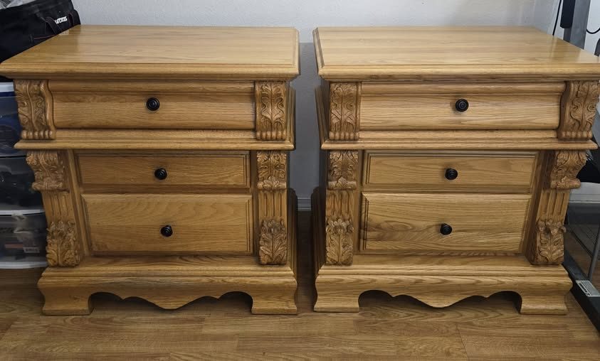 Ornate carved oak nightstand pair before restoration — honey amber finish, acanthus leaf column detail, scalloped apron base, Lacey WA