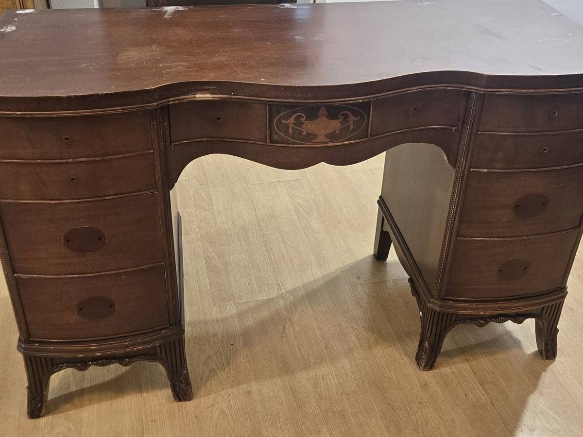 Vintage desk before restoration with worn dark finish and missing hardware