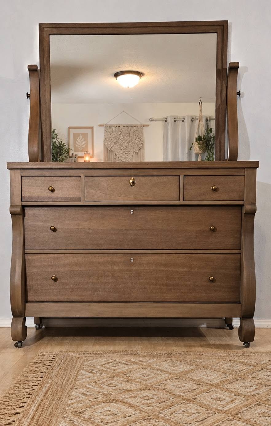 Grand Rapids Sligh mahogany dresser after refresh with mirror, lighter warm wood tone, brass knobs, and original casters