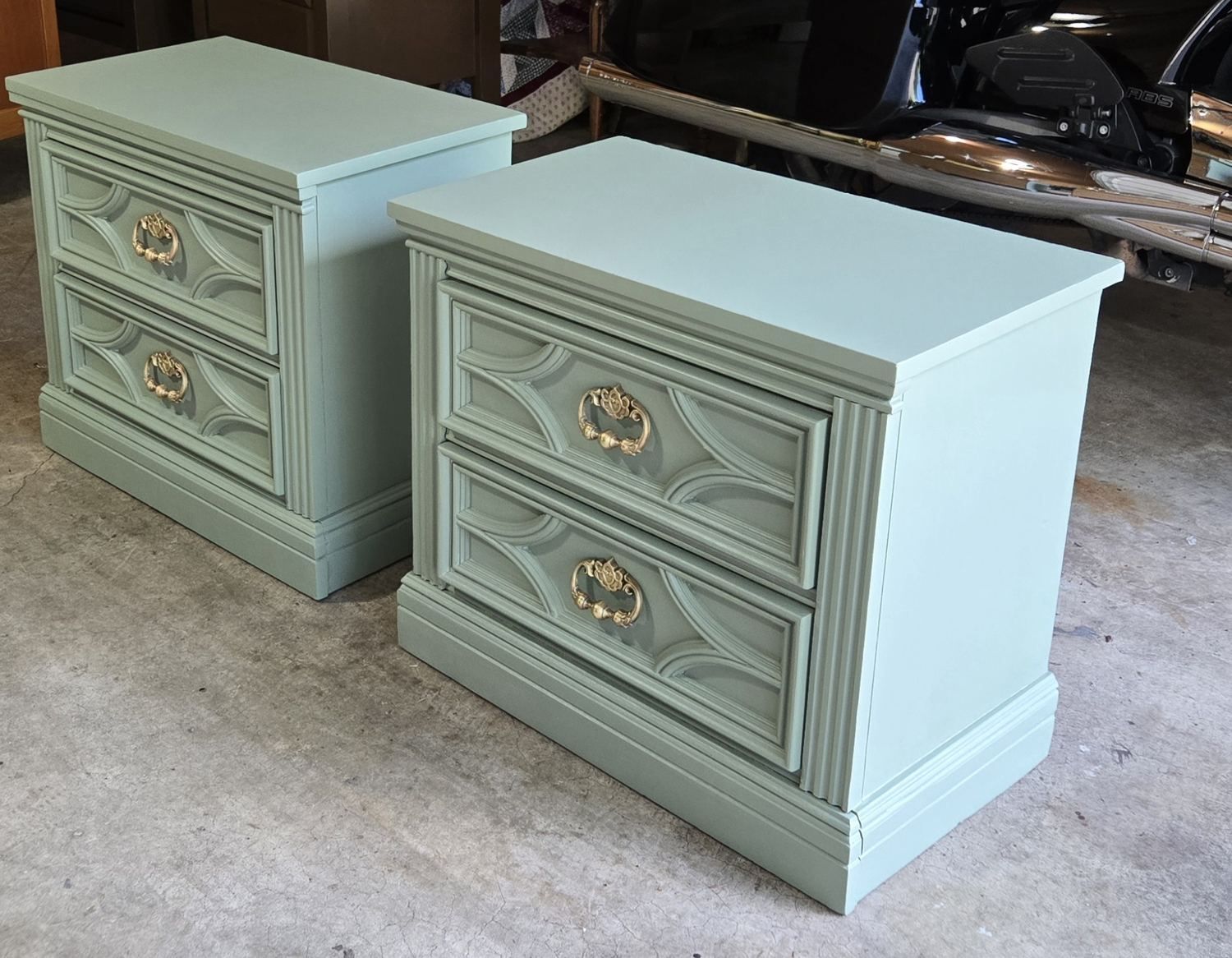 Soft green painted nightstands finished with gold hardware