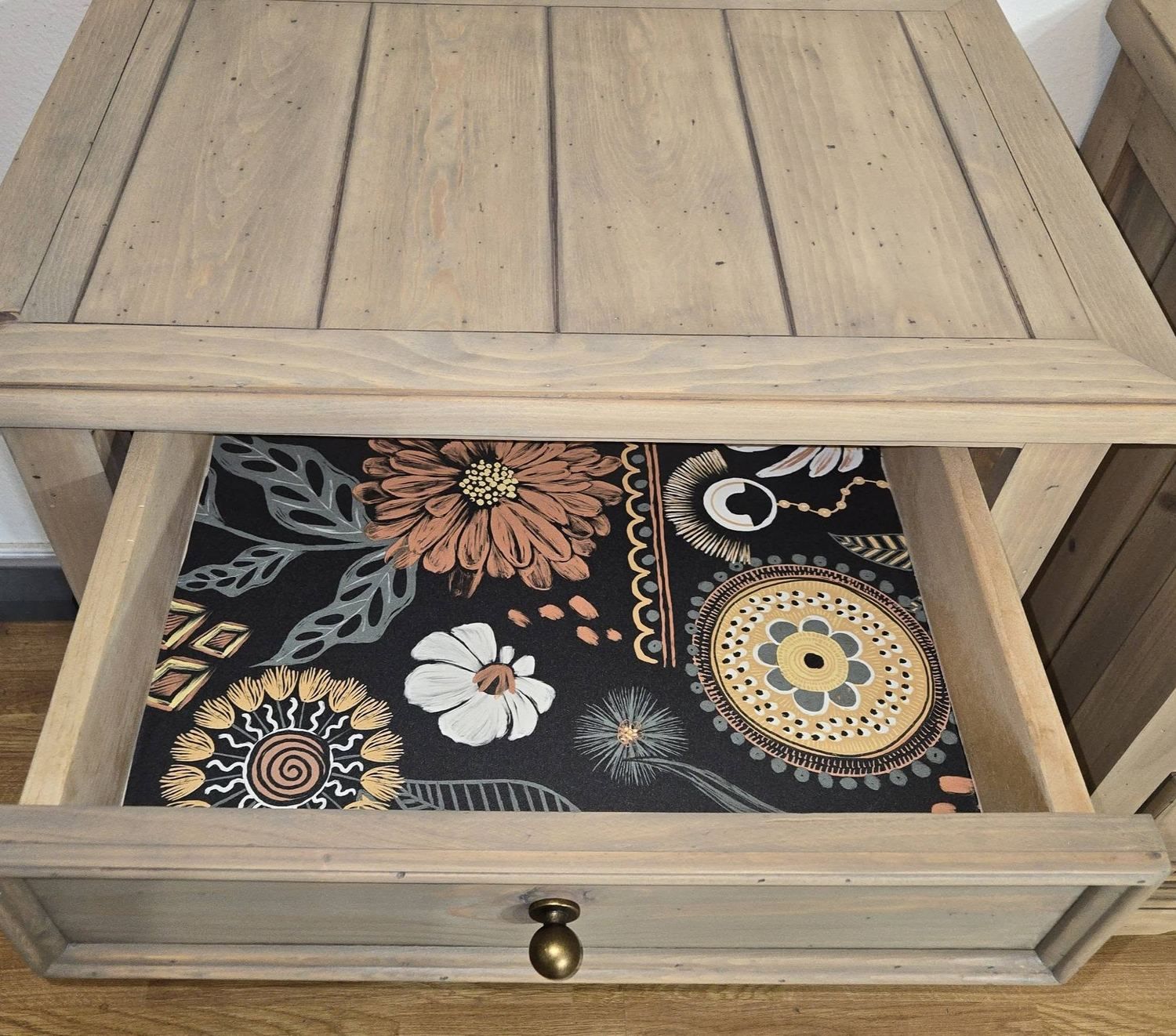 Patterned drawer detail inside a restored nightstand