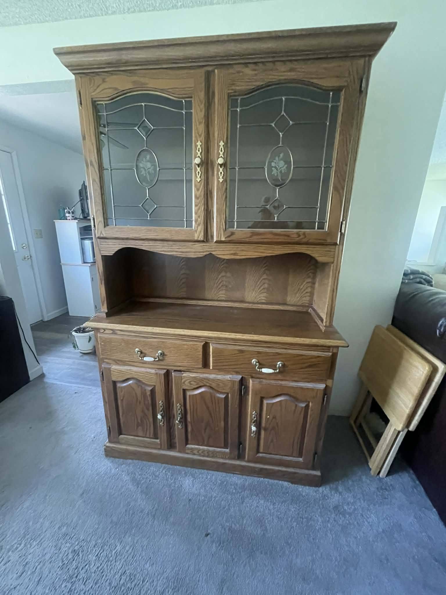 Oak hutch before restoration with dated warm oak finish and glass cabinet doors